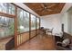 Relaxing screened-in porch with wooden floors, ceiling fan, and outdoor seating overlooking the backyard at Tbd Hudson Hills Rd, Pittsboro, NC 27312