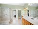 Elegant bathroom with a glass shower, double vanity and access to the bedroom at 1004 Dunleigh Dr, Burlington, NC 27215