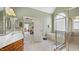 Bright bathroom featuring a separate shower, soaking tub, and a vanity with a sink at 1004 Dunleigh Dr, Burlington, NC 27215