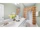 Bathroom with double vanity, bath and shower, toilet and lovely floral arrangement at 1004 Dunleigh Dr, Burlington, NC 27215