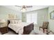 Comfortable bedroom with a decorative bed, side table, and a sunlit window at 1004 Dunleigh Dr, Burlington, NC 27215
