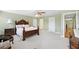 Well-lit primary bedroom showcases a decorative wooden bed frame and a view to the ensuite bathroom at 1004 Dunleigh Dr, Burlington, NC 27215