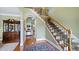 Inviting foyer with hardwood floors, staircase, and views into other living spaces at 1004 Dunleigh Dr, Burlington, NC 27215