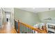 Hallway offering a view of the open floor plan, ceiling fan, and an indoor balcony at 1004 Dunleigh Dr, Burlington, NC 27215