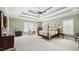 Elegant main bedroom featuring tray ceilings, two large windows, and carpet floors at 1004 Dunleigh Dr, Burlington, NC 27215