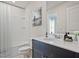 Modern bathroom with a sleek vanity, bathtub with shower, and stylish decor at 1041 Winding Spring Dr, Mebane, NC 27302