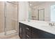 Modern bathroom featuring a double vanity with sleek fixtures and a glass-enclosed shower at 1041 Winding Spring Dr, Mebane, NC 27302