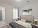 Comfortable bedroom featuring a large window with elegant curtains and a view into the bathroom at 1041 Winding Spring Dr, Mebane, NC 27302