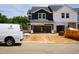 New construction townhome exterior showcasing the garage and uninstalled features under a cloudy sky at 1041 Winding Spring Dr, Mebane, NC 27302