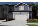 Exterior rendering of a blue and white townhome with a two-car garage and landscaped front yard at 1041 Winding Spring Dr, Mebane, NC 27302