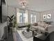 Inviting living room with neutral tones, stylish furniture, large windows, and elegant decor at 1041 Winding Spring Dr, Mebane, NC 27302