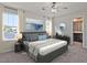 Serene main bedroom with a plush bed, large windows, modern decor, and an en-suite bathroom at 1041 Winding Spring Dr, Mebane, NC 27302