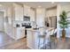 Modern kitchen featuring white cabinets, stainless steel appliances, granite counters, and a breakfast bar at 1045 Winding Spring Dr, Mebane, NC 27302