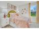 Cozy bedroom featuring bright natural light from large window, yellow accent decorations, and plush carpet at 1047 Winding Spring Dr, Mebane, NC 27302