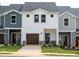 New construction townhomes with attached garages and lawn at 1047 Winding Spring Dr, Mebane, NC 27302