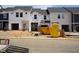 Image shows the exterior of homes under construction with Tyvek wrap, dumpsters, and a portable restroom at 1049 Winding Spring Dr, Mebane, NC 27302