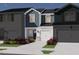 New construction townhome showing the exterior, landscaping, driveway and garage with blue and gray color scheme at 1049 Winding Spring Dr, Mebane, NC 27302