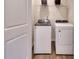 Functional laundry room with modern, full-size washer and dryer units and wire shelving at 1049 Winding Spring Dr, Mebane, NC 27302