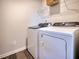 Laundry area featuring a Whirlpool washer and dryer with shelving for storage at 1051 Winding Spring Dr, Mebane, NC 27302