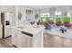Open concept living area with stainless steel appliances, dining area, and an abundance of natural light at 1051 Winding Spring Dr, Mebane, NC 27302