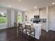 Kitchen showcasing granite island, white cabinets, stainless steel appliances, and an eat-in kitchen area at 1053 Winding Spring Dr, Mebane, NC 27302