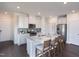Kitchen featuring island, white cabinets, stainless steel appliances, granite counters, and barstool seating at 1053 Winding Spring Dr, Mebane, NC 27302