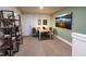 Home office with desk, chair, bookshelf, carpet, and natural light at 1053 Winding Spring Dr, Mebane, NC 27302