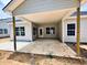 Back porch has a light ceiling, windows, door and support beams, and a large concrete slab floor at 1085 Fairhaven Dr # 49, Mebane, NC 27302