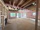 Unfinished basement with visible framing, pink insulation, electric fireplace, and windows at 1085 Fairhaven Dr # 49, Mebane, NC 27302
