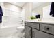 This bathroom features a shower-tub combo, gray vanity and neutral colored walls at 1085 Fairhaven Dr # 49, Mebane, NC 27302