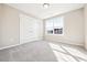 This bedroom features neutral colored walls, plush carpet, a window, and a closet at 1085 Fairhaven Dr # 49, Mebane, NC 27302