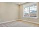 This bedroom features plush carpet, neutral walls, and a large window at 1085 Fairhaven Dr # 49, Mebane, NC 27302