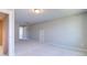 A spacious bedroom with plush carpet and access to another room at 1085 Fairhaven Dr # 49, Mebane, NC 27302