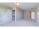 Neutral bonus room with carpeted floors, neutral walls and a door to a hallway at 1085 Fairhaven Dr # 49, Mebane, NC 27302