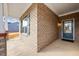 A covered front porch with a decorative window, a door with glass panes, and gray brick at 1085 Fairhaven Dr # 49, Mebane, NC 27302