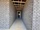 View through the framed entrance of a new home under construction, showcasing the brick facade at 1085 Fairhaven Dr # 49, Mebane, NC 27302