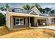 New construction home featuring gray brick, dormer window, and a covered porch with wooden pillars at 1085 Fairhaven Dr # 49, Mebane, NC 27302