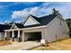 Inviting single-story home with a brick-accented front, an attached two-car garage, and sleek siding at 1085 Fairhaven Dr # 49, Mebane, NC 27302