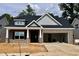 Charming single-story home featuring a brick facade, an attached two-car garage, and classic architectural detailing at 1085 Fairhaven Dr # 49, Mebane, NC 27302