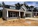 Attractive single-story home showcasing brick and gray siding, a two-car garage, and a welcoming front porch at 1085 Fairhaven Dr # 49, Mebane, NC 27302