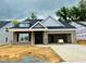 Charming new home featuring gray brick, a dormer window, and an attached two-car garage at 1085 Fairhaven Dr # 49, Mebane, NC 27302