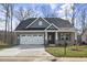 Charming single-story brick home featuring a two-car garage and a well-manicured front lawn at 1085 Fairhaven Dr # 49, Mebane, NC 27302