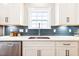 Kitchen sink with stainless steel appliances, shaker cabinets, and a decorative backsplash at 1085 Fairhaven Dr # 49, Mebane, NC 27302