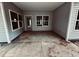 A concrete patio area featuring vinyl siding, a sliding glass door, and several windows at 1085 Fairhaven Dr # 49, Mebane, NC 27302