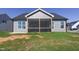 Exterior back view of home with screened in porch and gray vinyl siding at 1085 Fairhaven Dr # 49, Mebane, NC 27302