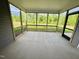 Inviting screened porch with views of backyard, trees, and pond at 1085 Fairhaven Dr # 49, Mebane, NC 27302