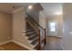 Staircase with wood and iron balusters leads to the upper level of the home at 1085 Fairhaven Dr # 49, Mebane, NC 27302
