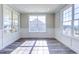 Light-filled room with large windows, wainscoting, and luxury vinyl plank flooring at 1085 Fairhaven Dr # 49, Mebane, NC 27302