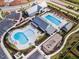 Aerial view of community amenities, including swimming pools, playground, and clubhouse at 1125 Sun Springs Rd, Wake Forest, NC 27587