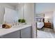 Elegant bathroom featuring a gray vanity with a white countertop and a peek into the bedroom, creating a serene space at 1125 Sun Springs Rd, Wake Forest, NC 27587